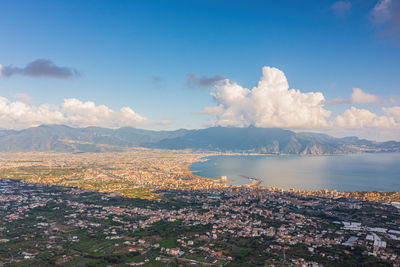 Scenic view of sea and cityscape against sky