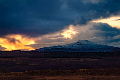 Scenic view of mountains against sky during sunset