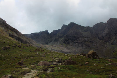 Scenic view of mountains against cloudy sky