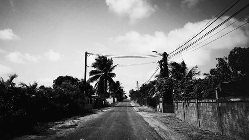 Road amidst trees against sky