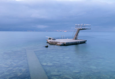 Fishing boat in sea against sky