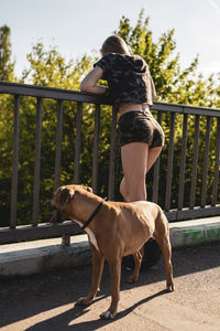 Man with dog on railing