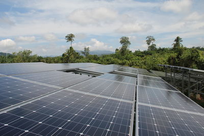 Solar panels against cloudy sky