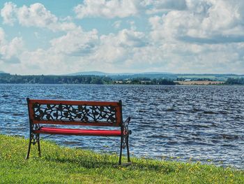 Empty bench on lakeshore