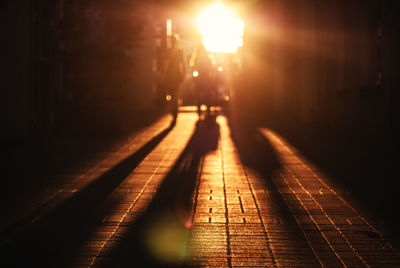 Shadow of people on footpath during sunset