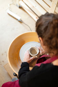 Ceramist artist female working in her atelier with the pottery wheel