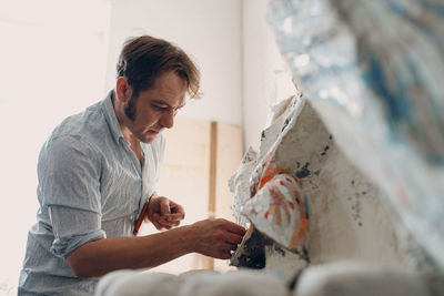 Side view of man working at home