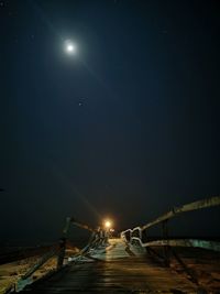 Illuminated lights against sky at night