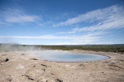 Scenic view of landscape against blue sky