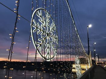 Low angle view of illuminated ferris wheel against sky