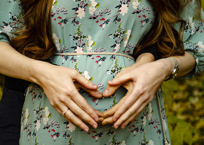 Midsection of woman holding bouquet