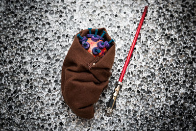 Close-up of hand holding toy over white background