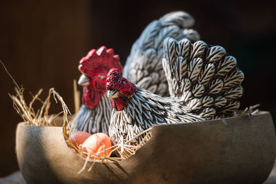 Clay hen and egg, molded from clay and through heat, in wood basket.