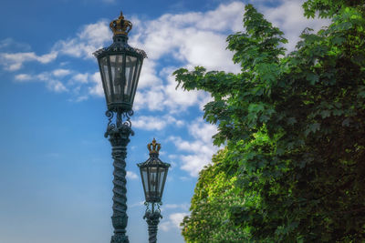 Low angle view of street light against cloudy sky