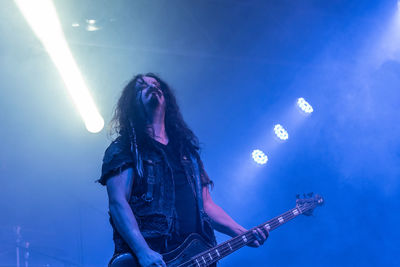 Man playing guitar at music concert