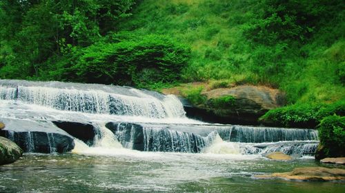 Scenic view of river flowing through rocks