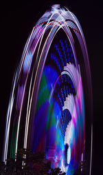 Low angle view of illuminated ferris wheel at night