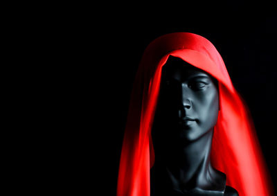 Close-up of buddha statue against black background