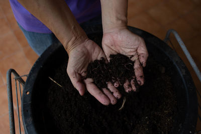 High angle view of man with mud in hand