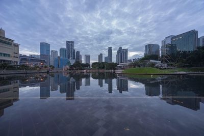 View of cityscape against cloudy sky