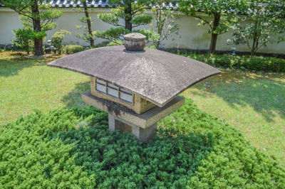 Built structure by trees against plants