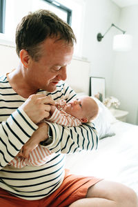 Closeup portrait of a dad holding his newborn daughter