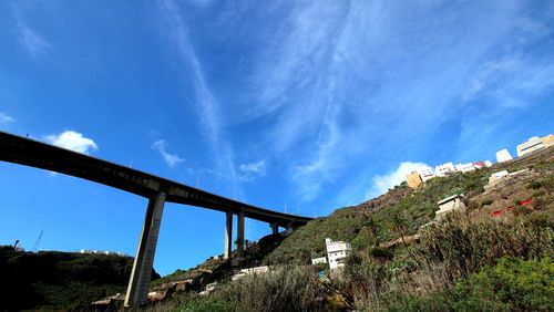 Low angle view of bridge against blue sky