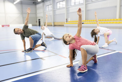 Elementary students exercising together at school sports court