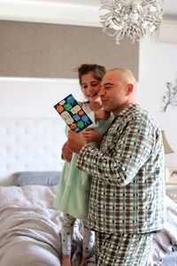 Father and daughter reading book at home