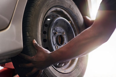 Cropped hand of man washing car