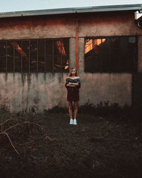 Portrait of young woman standing on land