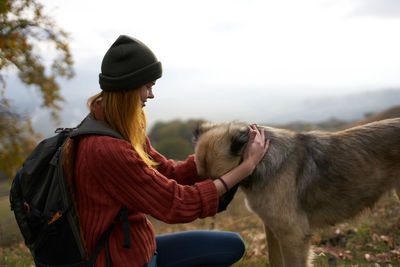 Rear view of woman with horse