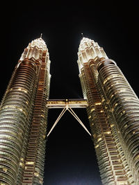Low angle view of illuminated tower against sky at night