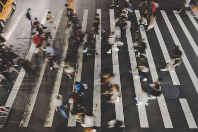 Blurred motion of people crossing road 