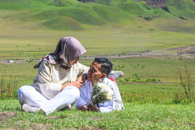 Rear view of couple on field