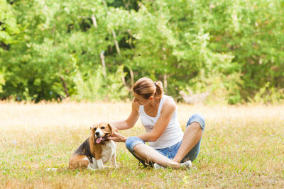 Young woman with dog on field