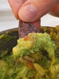 Close-up of person preparing food in plate