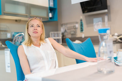 Beautiful woman sitting at store