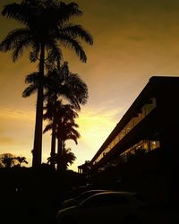 Silhouette palm trees against sky during sunset