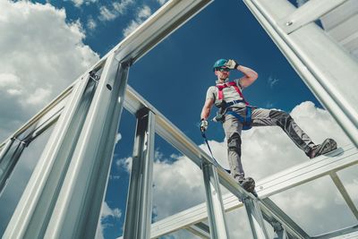 Low angle view of man standing against sky