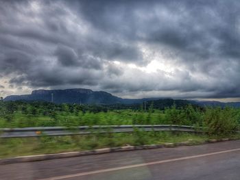 Scenic view of mountains against cloudy sky