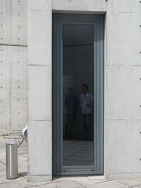 Man standing in front of door of house