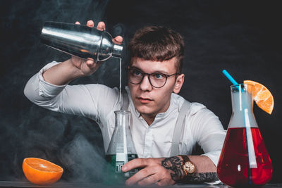 Young man mixing drinks
