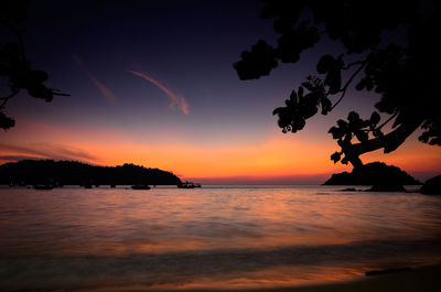 Scenic view of sea against orange sky