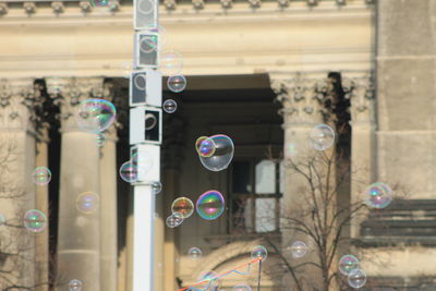 Low angle view of bubbles against building