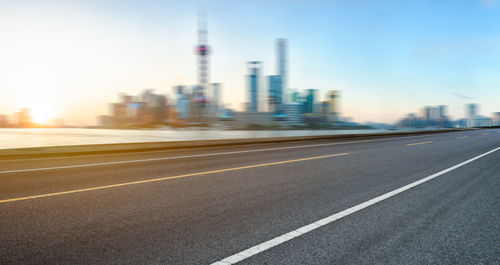 Blurred motion of road against buildings in city