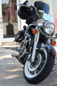 Close-up of motorcycle parked on road