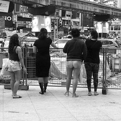 Rear view of people walking in city
