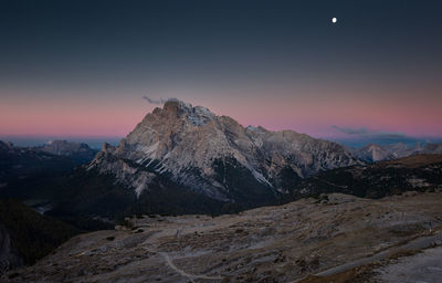 Scenic view of mountains against sky at dusk