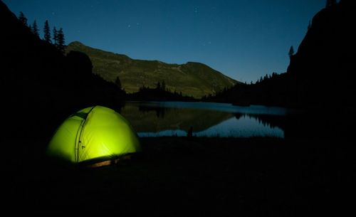 Scenic view of lake against sky at night